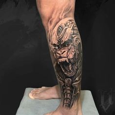 a man's leg with a tattoo on it that has an image of a demon