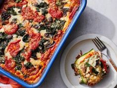 a blue casserole dish with spinach and cheese on it next to a slice of zucchini