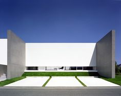 a white building with grass in front of it