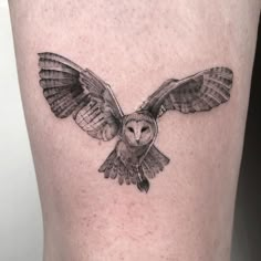 an owl tattoo is shown on the leg