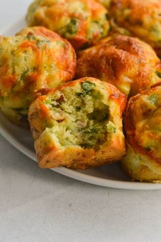 broccoli and cheese muffins on a white plate