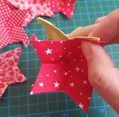 someone is cutting out the fabric to make a star ornament