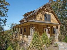 a small wooden house sitting on top of a lush green hillside