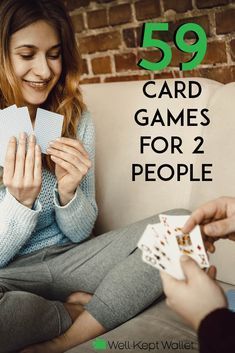 a woman sitting on a couch playing cards with another person holding one card and the other hand