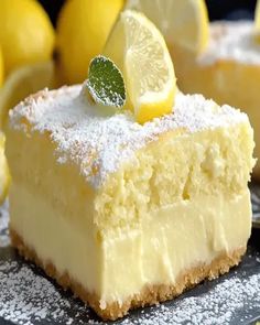 a piece of cake with lemons and powdered sugar on top, sitting on a plate