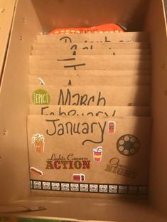 a cardboard box with some writing on it and various items in the bottom half of it