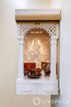 the shrine is decorated in white and features an image of lord ganesha on it