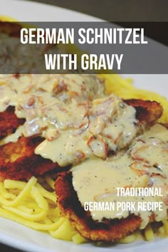 german schnitzel with gravy on top of pasta in a white plate