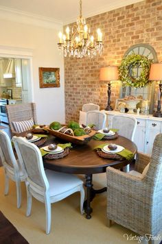 the dining room table is set with white chairs