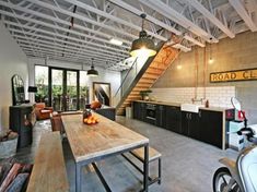 an open kitchen and living room with stairs