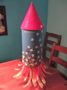 a paper rocket sitting on top of a wooden table