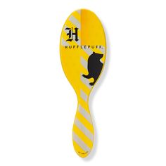 a yellow and white striped paddle with a black cat on it's side, in the shape of a spoon