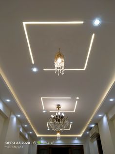 an empty room with chandeliers and lights on the ceiling is pictured in this image