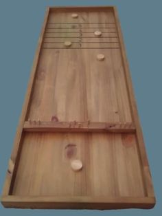 an image of a wooden board with buttons and strings on the back side that is made out of wood