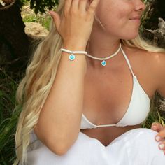 Say hello to endless summer vibes with our Sun Bleached Beaded Choker! This cool and breezy choker features stunning white puka shell beads, bringing that laid-back, sun-kissed beach feel to any outfit. The crisp white shells evoke memories of sandy shores and lazy days under the sun, making it a must-have for any beach lover. Lightweight and super comfy, the Sun Bleached Beaded Choker is perfect for everyday wear, whether you're heading to a beach party or just want to add a touch of coastal charm to your style. Pair it with our other beachy accessories for a complete sun-soaked look! - 14" beaded choker length + 2" extender chain - 4mm white rondelle puka shell beads - Lobster clasp closure with brand tag - Features a small Aqua / White St. Christopher Adjustable Beaded Shell Necklace For Vacation, White Beaded Choker For Vacation, Resizable Summer Jewelry For Vacation, Adjustable Shell Beaded Necklaces With Beachy Style, Adjustable Beachy Shell Beaded Necklaces, Beachy Adjustable Beaded Necklaces For Vacation, Adjustable Beaded Shell Necklace For Beach Season, Adjustable Shell Necklace For Summer Festivals, Handmade Adjustable Shell Necklace For Summer