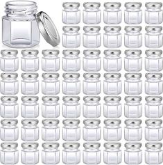 many glass jars with lids are arranged in the shape of a grid on a white background