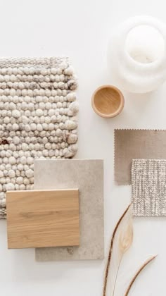 the materials needed to make a rug are laid out on a white surface, including wood and wool