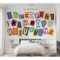 a bedroom with colorful letters on the wall