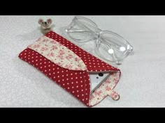 a red and white polka dot envelope with eyeglasses