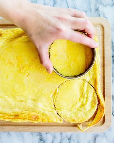 a person is dipping something into a pancake