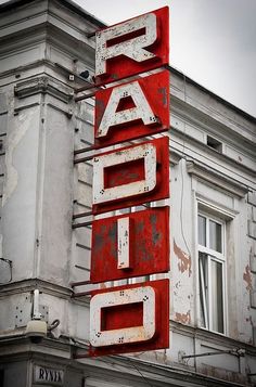 an old sign that is on the side of a building