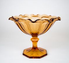 a yellow glass bowl sitting on top of a table