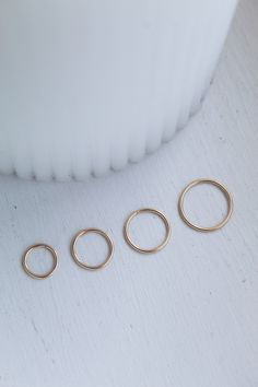 14K Gold Nose Ring, seamlessly lightweight and extremely easy to wear, allowing for maximum comfort and durability. The gentle design creates a smooth finish, resulting in a dainty piece. Simply thread through the nose, it's that easy! A minimalist essential. The ring is designed and produced using the highest quality and care, allowing for fantastic durability and sustainability. Will arrive beautifully packaged. Not to mention the entire design and packing process being environmentally friendl Nose Ring Sizes, Nose Ring Gold, Gold Nose Hoop, Gold Nose Ring, Gold Nose Stud, Skin Model, Unique Handcrafted Jewelry, Gold Nose Rings, Minimalist Accessories