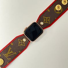 Introducing our wonderful "Wendy" Time to elevate your Apple Watch experience with the exquisite craftsmanship of our hand-crafted designer watchband, "Wendy." Crafted with precision and passion, this luxurious band combines soft, rich red leather with the iconic brown and gold LV monogram material sourced from authentic bags. The band features gold fitting connectors ensuring a secure attachment to your Apple Watch. For added convenience and comfort, two gold high-quality snaps have been incorp Brown Apple Watch Band, Luxury Brown Watches With Leather Strap, Adjustable Red Leather Watch Bands, Luxury Brown Watch For Gift, Gold Leather Watch Bands For Gifts, Gold Leather Watch Bands As Gift, Designer Adjustable Gold Leather Bracelet, Designer Gold Leather Bracelet Adjustable, Designer Gold Adjustable Leather Bracelet