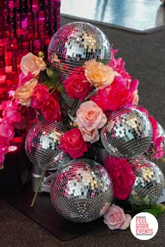 disco balls and pink flowers on a table