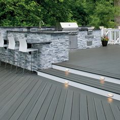 an outdoor kitchen and grill on a deck