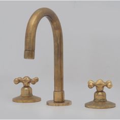 an old brass faucet with two matching handles