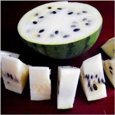 slices of watermelon sitting next to each other on a red tablecloth with black dots