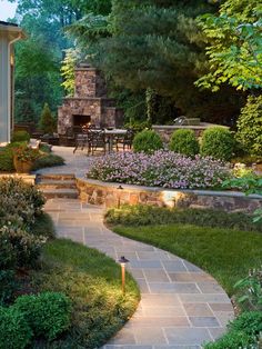 an outdoor patio with stone steps and landscaping