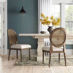 a dining room with blue walls and wooden floors