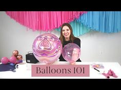 a woman sitting at a table with balloons in front of her and the words balloon 101