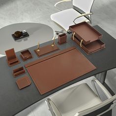 an assortment of brown leather items on a table