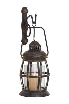 an old fashioned lantern with a candle in the middle and a chain hanging from it