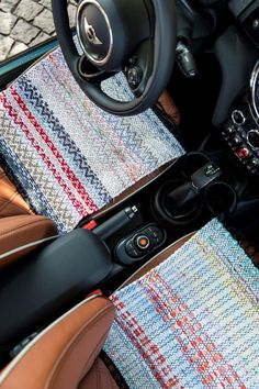 the interior of a car with leather trims and steering wheel controls, including an instrument