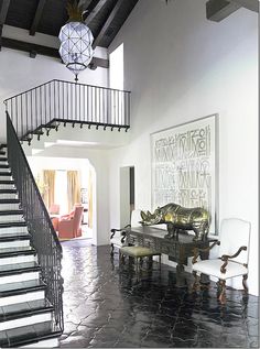 a living room filled with furniture and a staircase