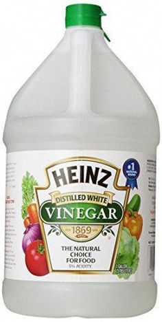 a gallon of henz distilled white vinegar with fresh vegetables on the side