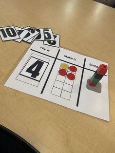 a wooden table topped with lots of cut out numbers and magnets on top of it