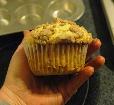 a person holding a muffin in their hand