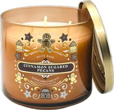 a candle that is sitting in front of a white background with the words cinnamon sugared pecans on it