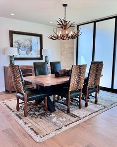 a dining room table with chairs and a chandelier