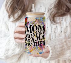 a woman holding a cup with the words mom, mommy, mamma mother printed on it