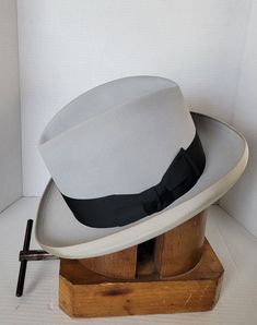 "Elevate your style with this beautiful elegant vintage homburg hat by Morrison. Crafted from high-quality materials, this hat is the perfect addition to any wardrobe. It's timeless design and superior craftsmanship ensure that it will be a staple in your wardrobe for years to come. Invest in this vintage accessory today and add a touch of sophistication to your look. This beautiful light grey with black contrasting ribbon is just stunning. Great for formal or semi formal event. Please view pict Fitted Short Brim Hat For Derby, Fitted Fedora With Short Brim For Derby, Fitted Wide Brim Hat For Derby, Fitted Fedora With Curved Brim For Derby, Classic Flat Brim Top Hat For Derby, Retro Short Brim Top Hat For Kentucky Derby, Elegant Brimmed Hats For Derby, Classic Brimmed Top Hat For Derby, Retro Formal Fedora With Wide Brim