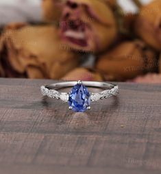 a tan and white gold ring with a blue sapphire