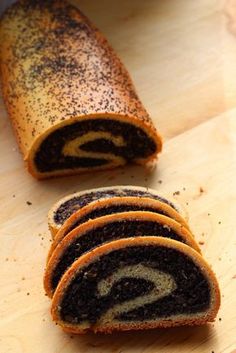 there are several slices of chocolate cake roll on the cutting board next to each other