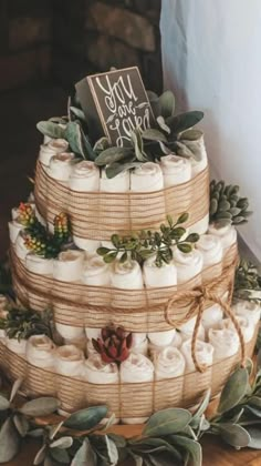 a three tiered cake made out of burlocks and wrapped in twine