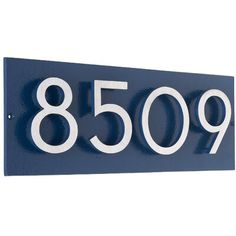 a blue metal house number sign with white numbers on the front and back of it